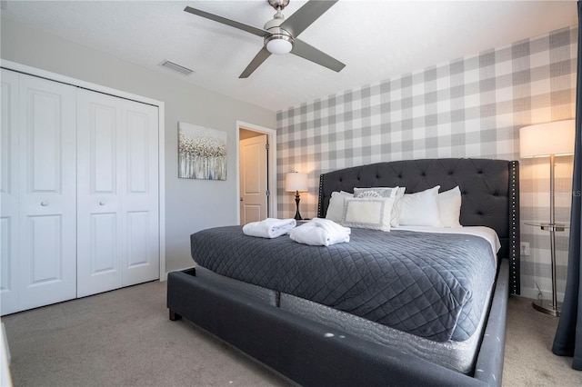 carpeted bedroom featuring a closet and ceiling fan