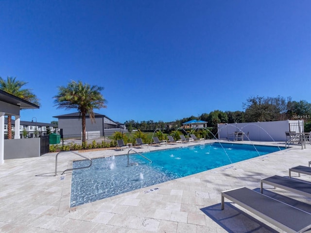 view of pool featuring pool water feature and a patio area