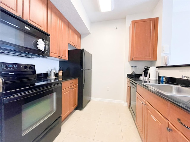 kitchen featuring sink, light tile patterned flooring, and black appliances