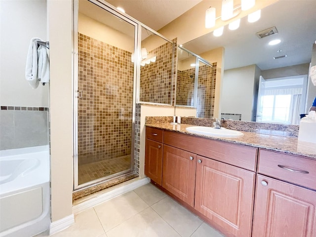 bathroom featuring tile patterned floors, plus walk in shower, and vanity