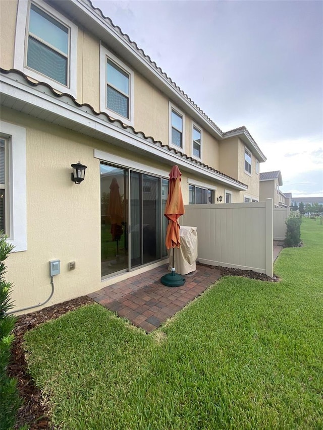 rear view of house featuring a yard