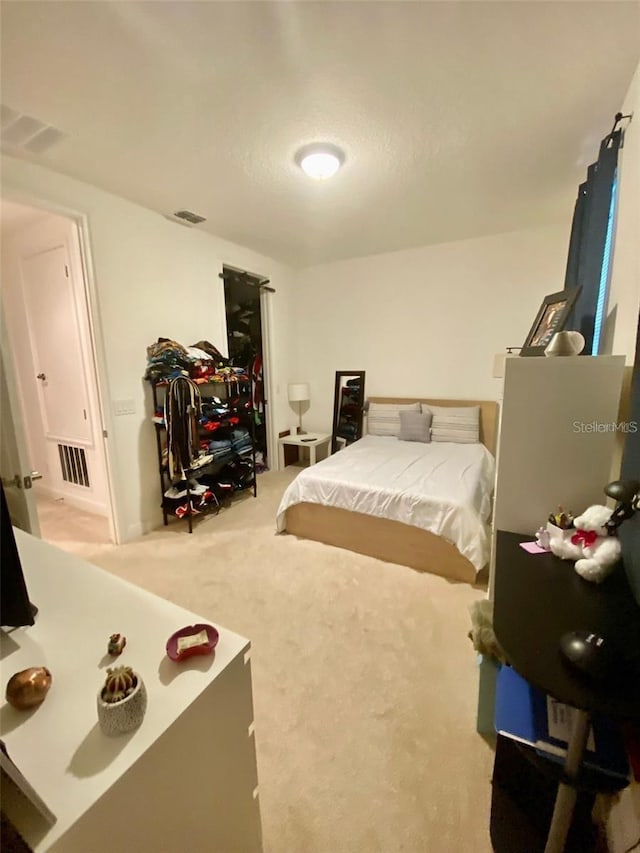 bedroom with light colored carpet