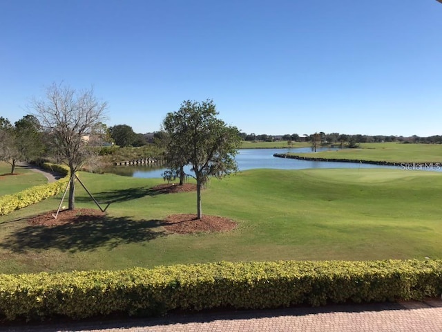 view of home's community featuring a yard and a water view