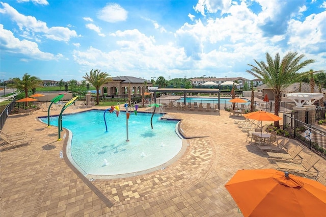 view of pool featuring pool water feature and a patio area