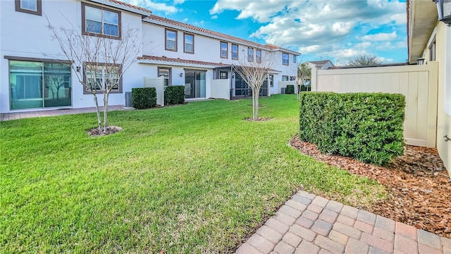 view of yard with fence and central AC