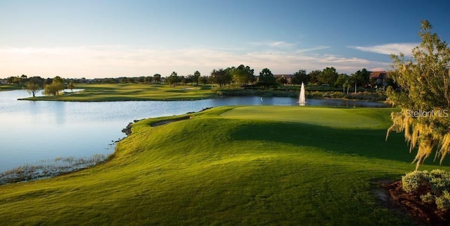 view of property's community featuring a water view, golf course view, and a yard