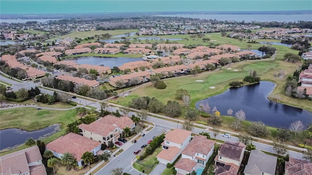 aerial view with a residential view, a water view, and golf course view