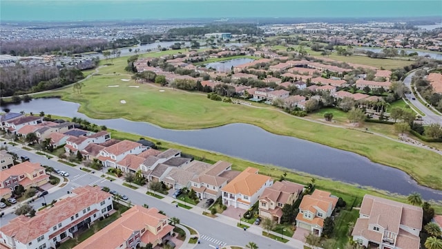 drone / aerial view with a residential view, a water view, and golf course view