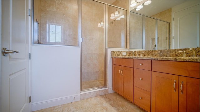 full bath with double vanity, a shower stall, a sink, and tile patterned flooring