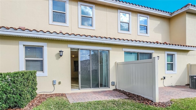 back of property with a patio and stucco siding