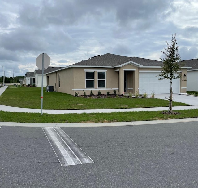 single story home with a garage, central air condition unit, and a front lawn