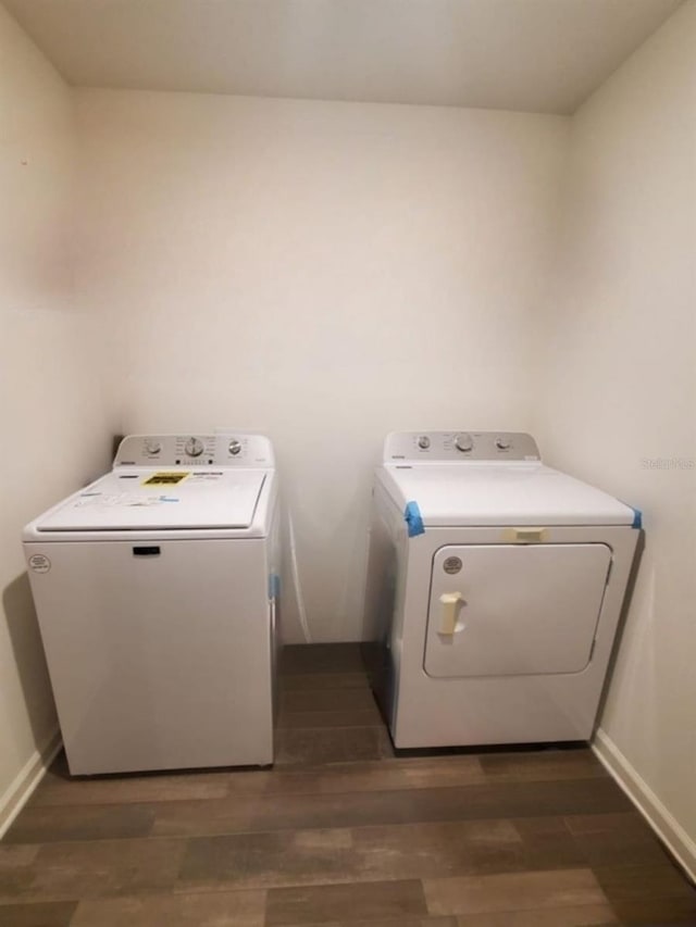 laundry area with dark hardwood / wood-style flooring and separate washer and dryer