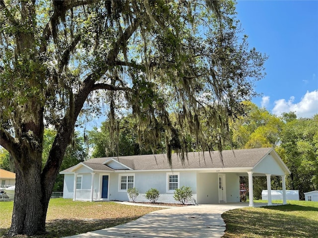 ranch-style house featuring a front yard and a carport