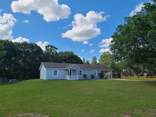 ranch-style home with a porch and a front yard