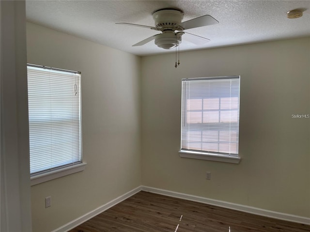 spare room featuring ceiling fan, dark hardwood / wood-style flooring, and a textured ceiling