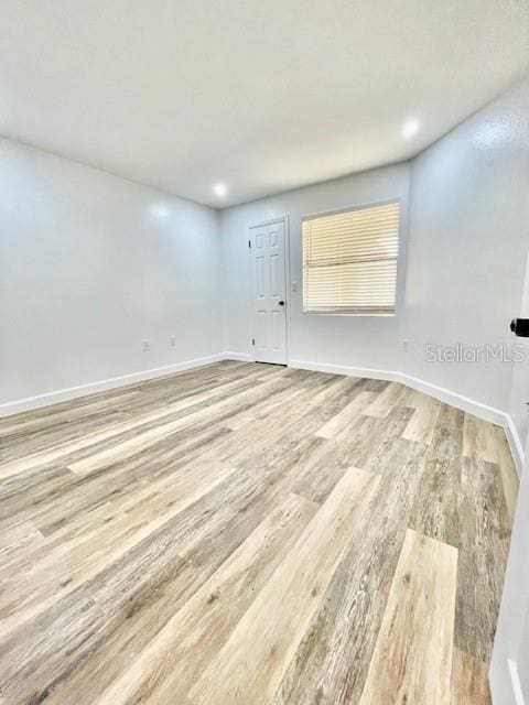 unfurnished room with hardwood / wood-style flooring