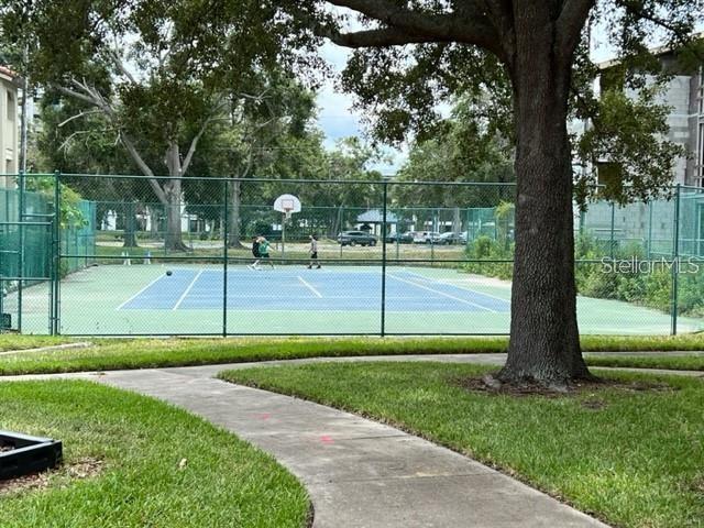 view of tennis court featuring basketball hoop