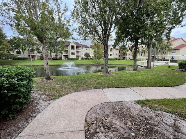 view of community featuring a water view and a lawn