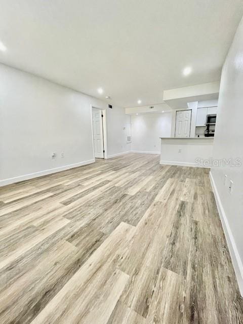 unfurnished living room with light hardwood / wood-style floors