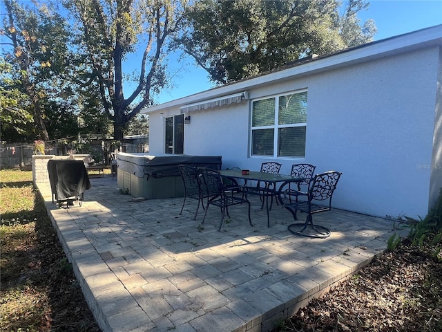 view of patio with grilling area and a hot tub