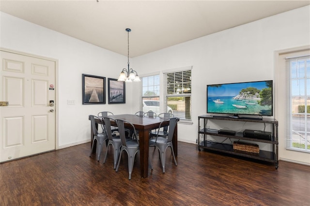 dining space featuring a chandelier and dark hardwood / wood-style floors