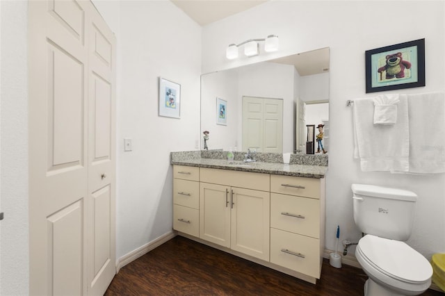 bathroom featuring hardwood / wood-style floors, vanity, and toilet