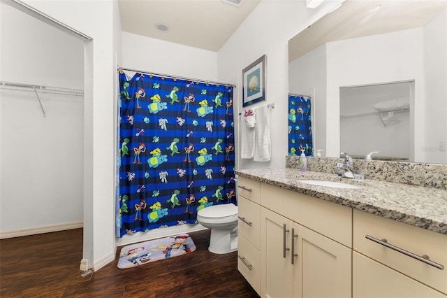 bathroom with a shower with shower curtain, wood-type flooring, vanity, and toilet