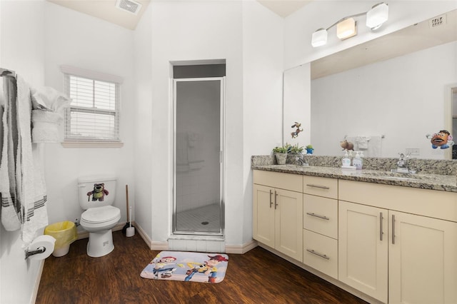 bathroom featuring toilet, vanity, wood-type flooring, and walk in shower