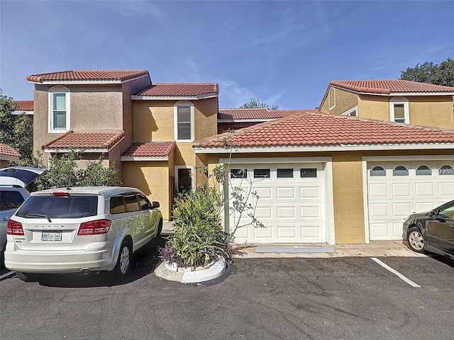 mediterranean / spanish-style home with a garage