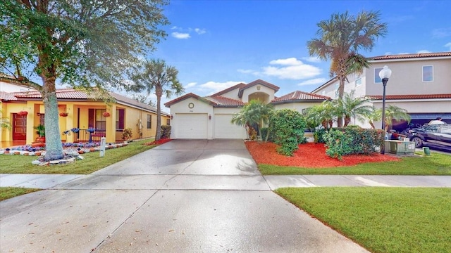 mediterranean / spanish-style house featuring a garage and a front lawn