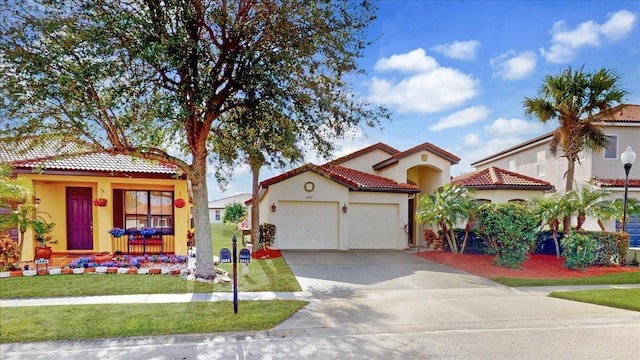 mediterranean / spanish house with a front lawn and a garage