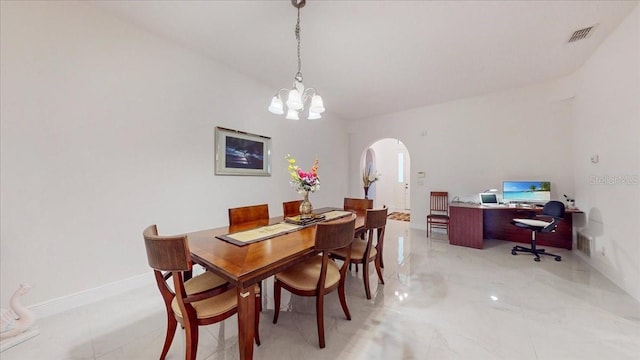 dining space with vaulted ceiling and a notable chandelier