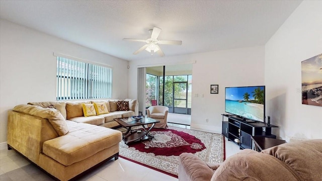 living room with ceiling fan, a textured ceiling, and a baseboard radiator