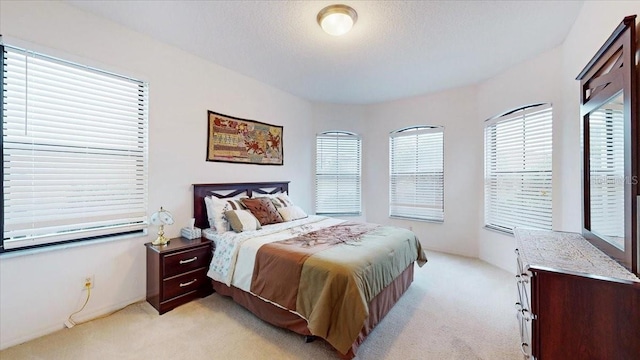 carpeted bedroom featuring a textured ceiling