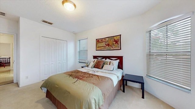 carpeted bedroom featuring a closet