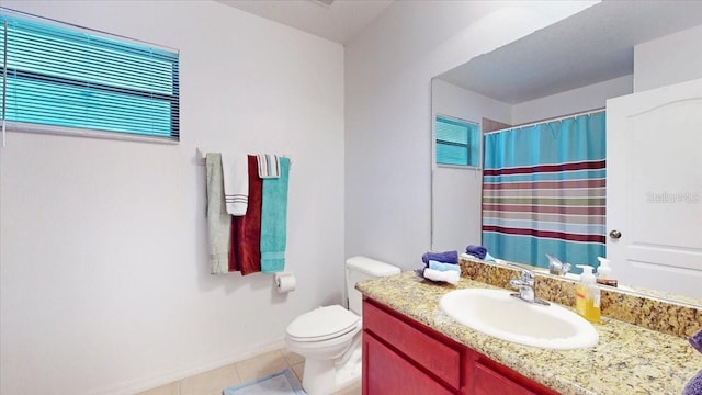 bathroom featuring tile patterned flooring, vanity, and toilet