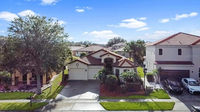 mediterranean / spanish-style home with a garage