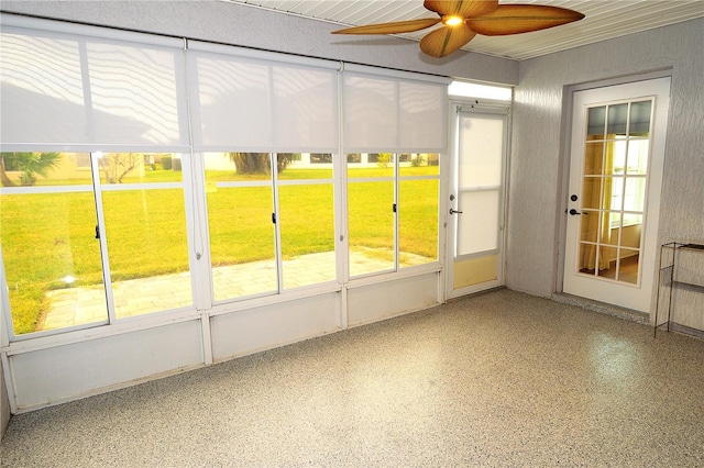 unfurnished sunroom with ceiling fan