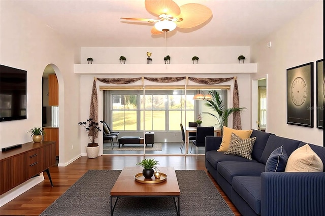 living room featuring ceiling fan and dark hardwood / wood-style flooring