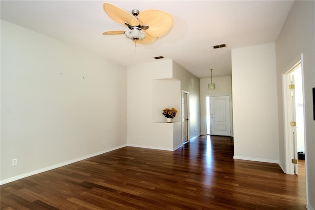 spare room with dark hardwood / wood-style floors and ceiling fan