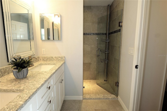 bathroom featuring vanity, tile patterned floors, and a shower with door