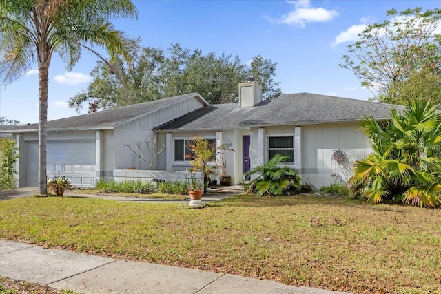 ranch-style home with a garage and a front lawn