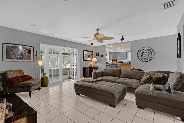 tiled living room featuring ceiling fan