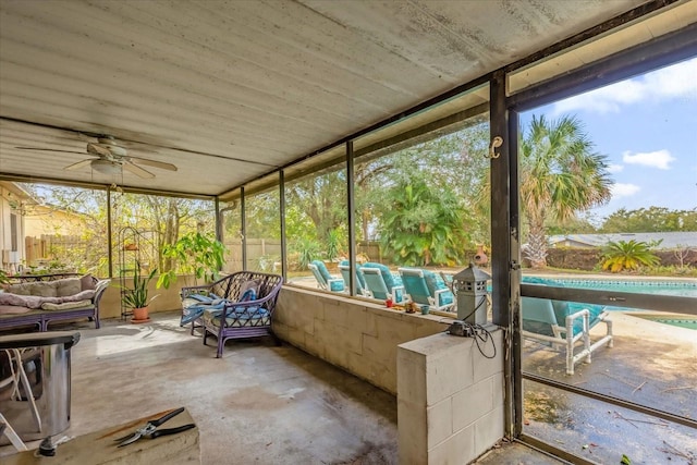 unfurnished sunroom with ceiling fan