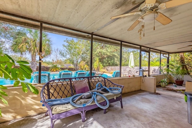 sunroom featuring ceiling fan and a healthy amount of sunlight