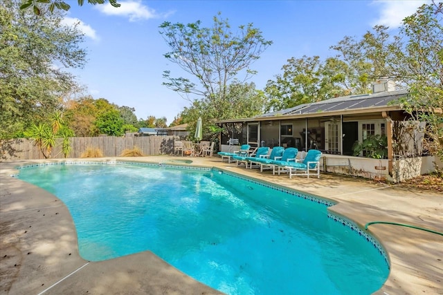 view of pool featuring a patio and a sunroom