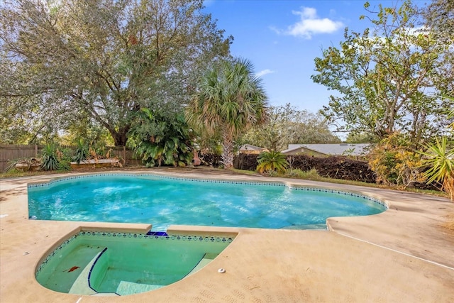 view of pool with an in ground hot tub