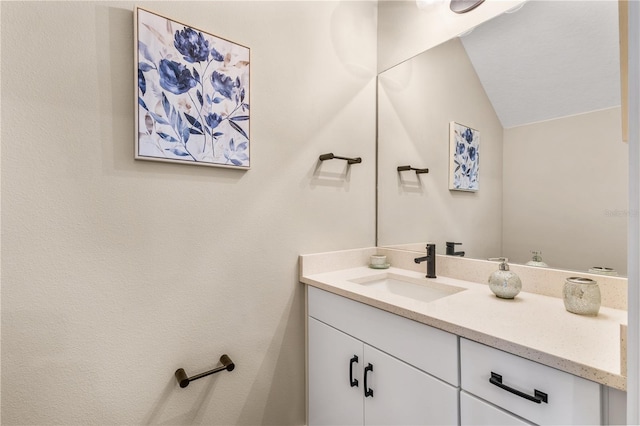 bathroom featuring vanity and vaulted ceiling