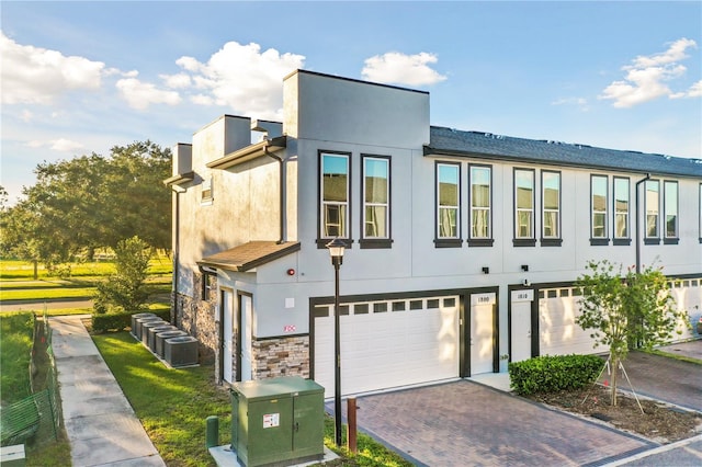 view of front of property with central AC and a garage