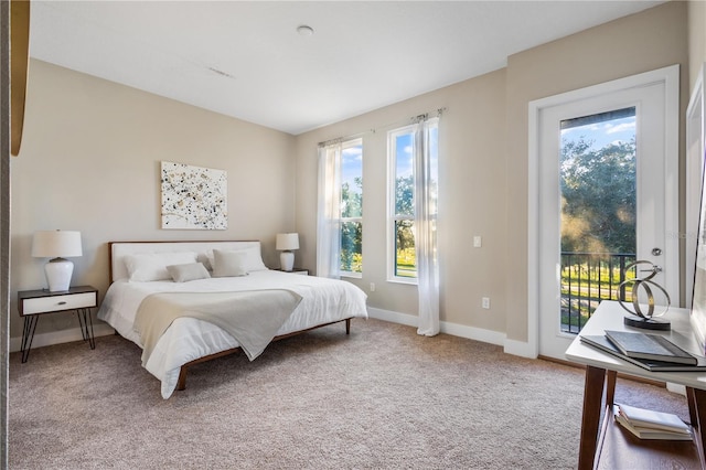 carpeted bedroom featuring access to outside